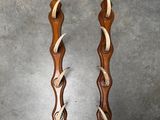 two pieces of wood with antelope carved into them sitting on a table