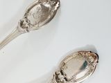 two spoons that are sitting on a table