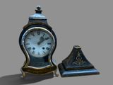 a small clock sitting next to a smaller clock on a table