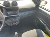 a dashboard of a car with a steering wheel and dashboard controls