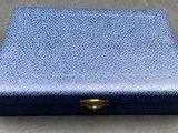 a blue box sitting on top of a table next to a wall