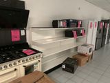 a stove and a refrigerator in a store with boxes on the floor