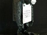 a statue of a gorilla with a sign on it ' s chest