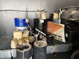 several buckets of food are sitting on a metal shelf