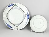 a white plate and a blue and white plate on a table