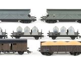 a lot of different types of toy trains on the tracks