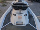 a white and black jet ski that is parked in a lot