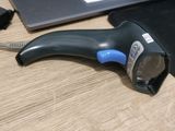 a black and blue hair dryer sitting on a table next to a laptop