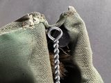 a close up of a zipper with a small metal object in it