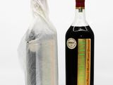 a bottle of liquor and a bag of tea on the table