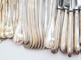 a lot of silver spoons and forks on the table