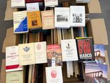 many books in a box on the floor