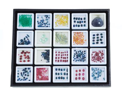 a close up of a box of dominos with different colors and shapes