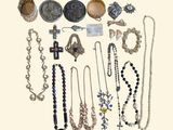 many different types of necklaces and bracelets on the table