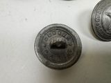 a close up of some old metal buttons on a table