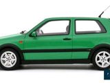 the green car is parked on a white surface with a white background