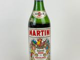 bottle of martini wine on a white surface with a white background