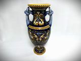 a blue and gold vase with two birds on it
