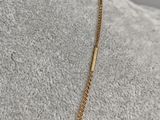 a gold chain necklace with a bar on a mannequin mannequin mannequin mannequin mannequin mannequin mannequin manne