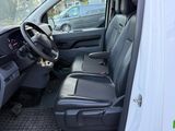 the interior of a white van with the driver ' s seat up