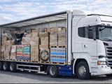 a truck with a trailer full of boxes on the back