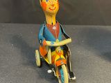 brightly colored figurines of a man on a tricycle