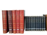 books are lined up in a row on a white surface