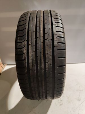 a close up of a tire on a table next to a cat