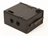 an old camera that is sitting on a white surface