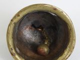 a close up of a metal object on a white surface