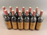 six bottles of wine are lined up in a row on a table