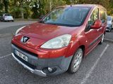 a small red car parked in a parking lot