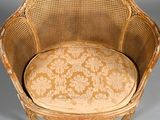 a wicker chair with a floral pattern on it