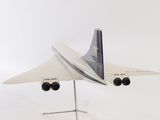a model of a plane on a stand on a white surface