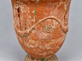 an image of a very old looking vase on a gray background