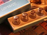 four salt and pepper shakers in a box