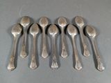 six silver spoons sitting on top of a table next to each other