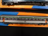 two train cars that are sitting next to each other