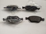 four different types of brake pads on a white surface