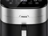 a black and silver air fryer sitting on top of a white surface