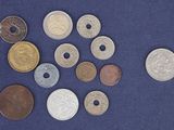 a lot of coins that are on a blue surface
