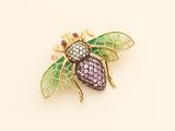 an image of a bee brooch with pink, green and purple stones