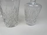 two glass vases sitting next to each other on a table