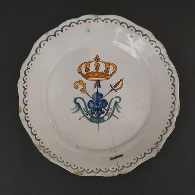 a plate with a crown on it sitting on a table