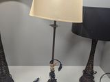 two lamps sitting on a table with a lamp on top of it