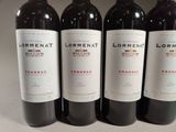 three bottles of red wine are lined up on a table