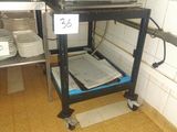 a small cart with plates on it in a kitchen