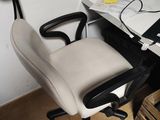 a computer desk with a chair and a laptop on it