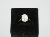 a white diamond ring in a black velvet box on a white background