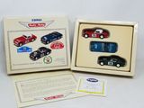 two boxed toy cars are in a box on a white surface